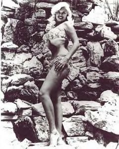 Jayne Mansfield by the waterfall near her pool.
